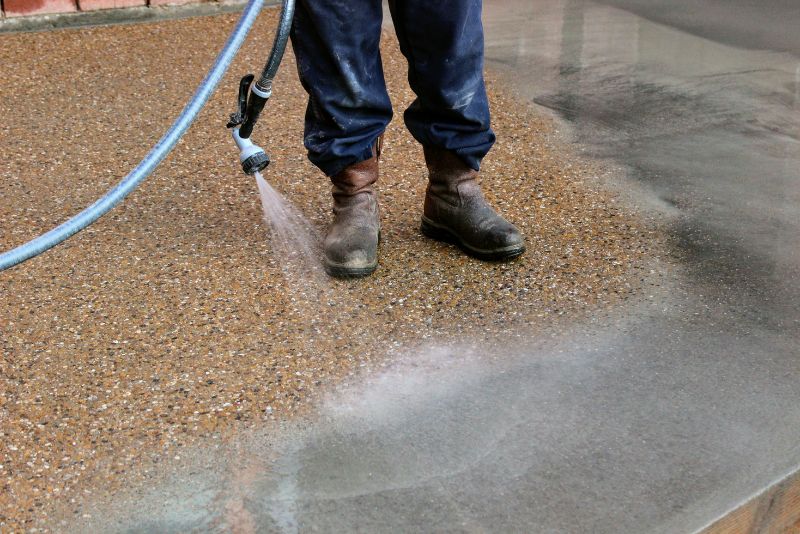 Concreter pressure-washing an exposed aggregate surface by Concrete Rockhampton Experts