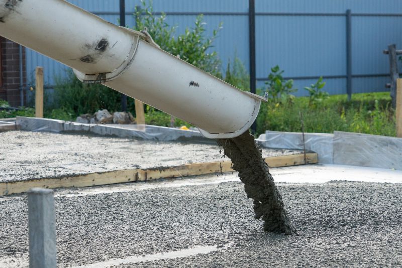Concrete mix flowing from a chute onto a freshly prepared slab by Concrete Rockhampton Experts