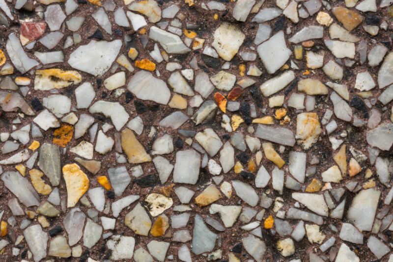Close-up of an exposed aggregate concrete surface showing the pebble texture